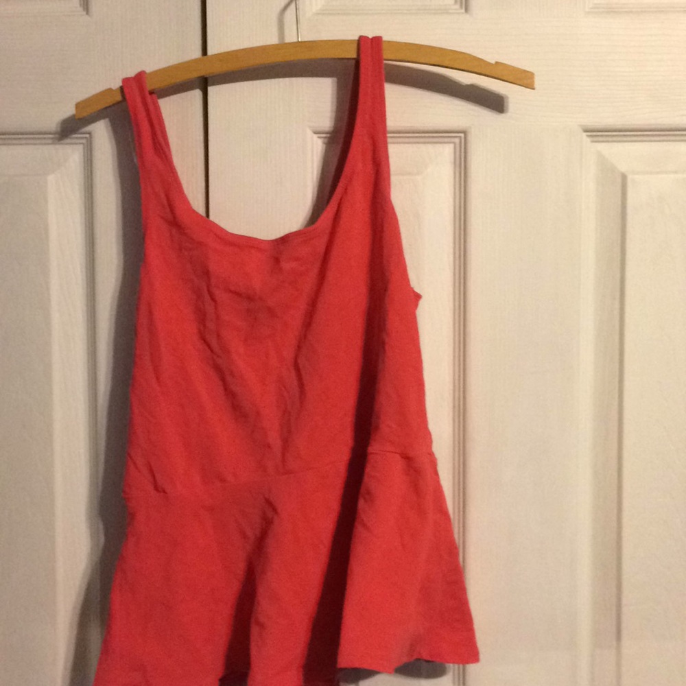 Pink tank top flares at the bottom